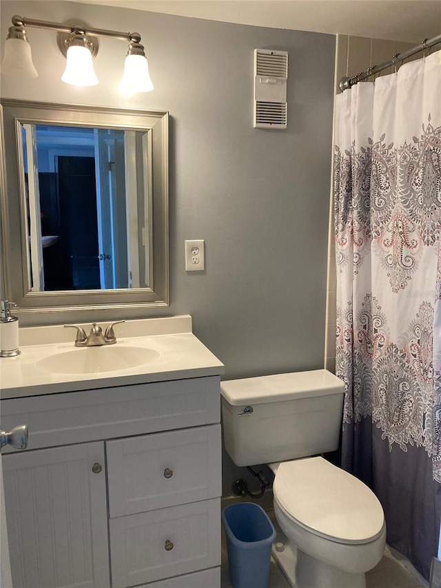 bathroom featuring vanity, toilet, and a shower with shower curtain