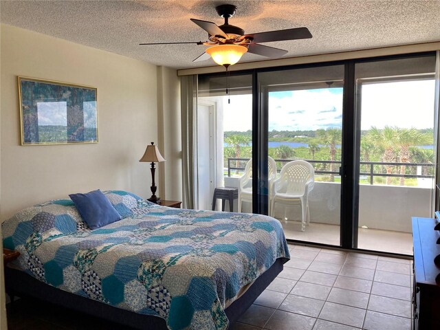 tiled bedroom featuring a textured ceiling, ceiling fan, and access to exterior