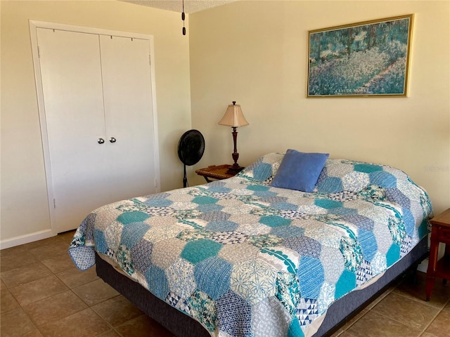 tiled bedroom with a closet