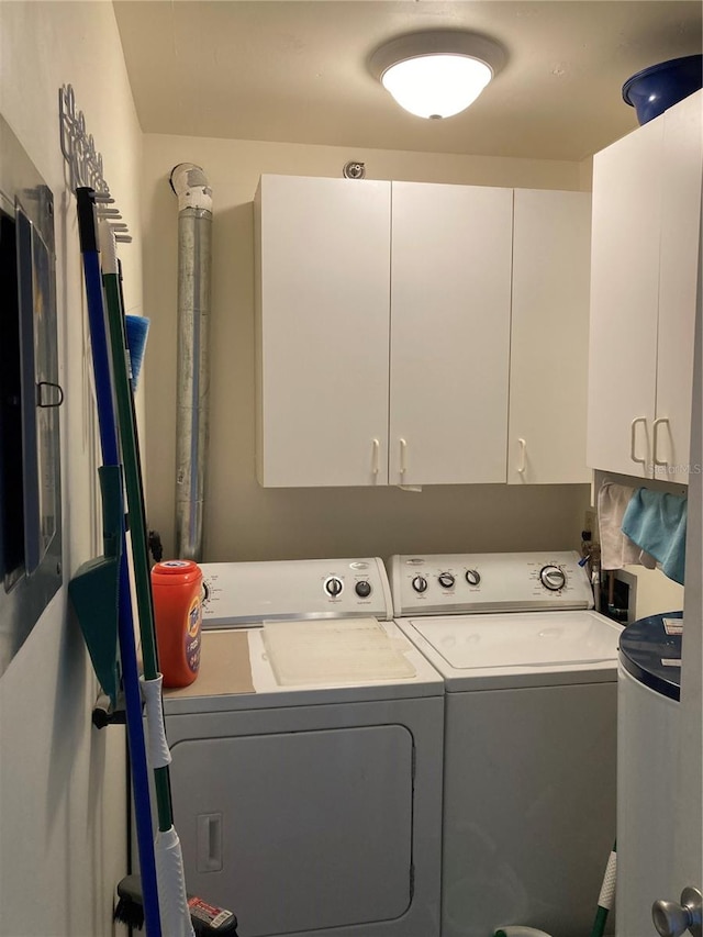 washroom with cabinets and independent washer and dryer