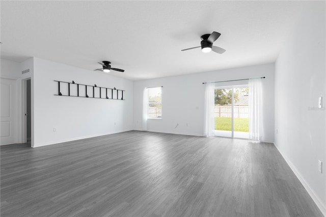 empty room featuring ceiling fan and dark hardwood / wood-style flooring