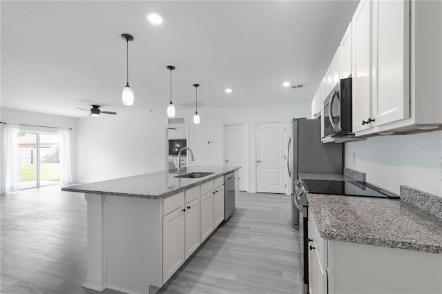 kitchen with white cabinetry, sink, pendant lighting, and appliances with stainless steel finishes