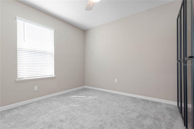 carpeted empty room featuring ceiling fan