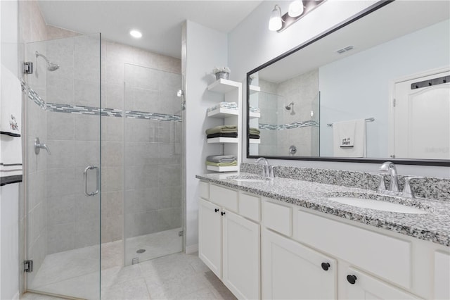 bathroom with walk in shower, tile patterned flooring, and vanity