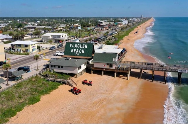 bird's eye view with a water view and a beach view