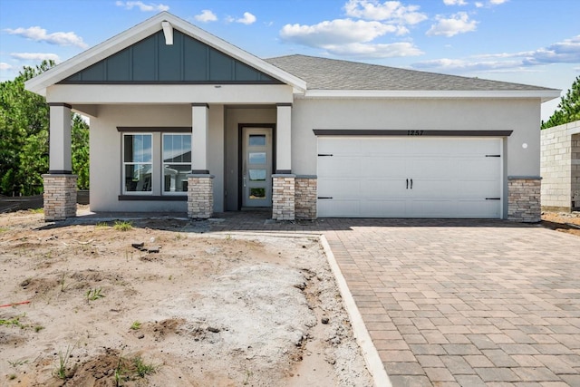 view of front of house with a porch and a garage