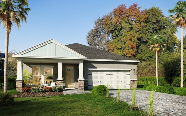 craftsman-style house featuring a front lawn, covered porch, and a garage