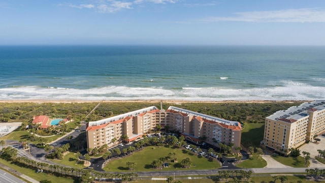 birds eye view of property with a water view and a beach view