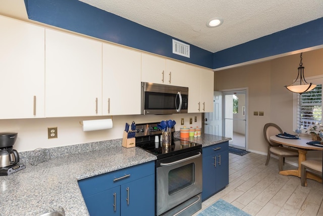 kitchen with white cabinets, decorative light fixtures, light hardwood / wood-style flooring, appliances with stainless steel finishes, and blue cabinets