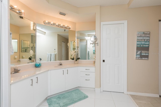 bathroom with tile patterned floors, vanity, and a bathing tub