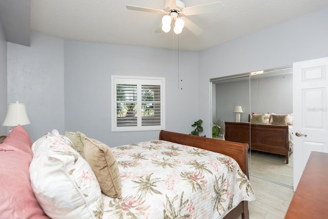 bedroom featuring hardwood / wood-style flooring, ceiling fan, a closet, and a textured ceiling