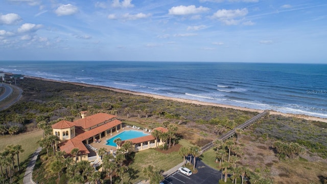 birds eye view of property featuring a beach view and a water view