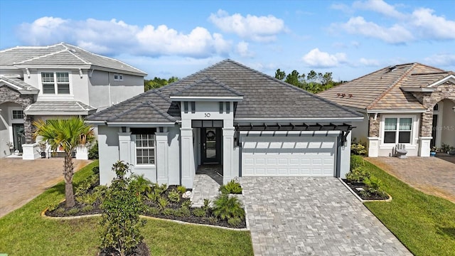 view of front facade featuring a front lawn and a garage