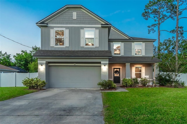 view of front of home with a yard and a garage