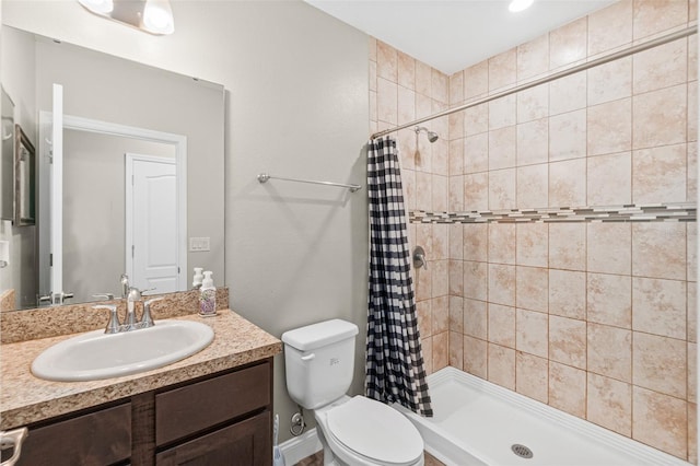 bathroom featuring vanity, toilet, and walk in shower