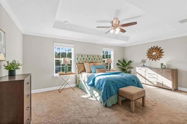 bedroom with a raised ceiling, multiple windows, ceiling fan, and crown molding