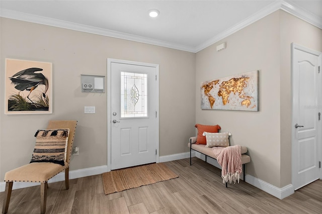 entrance foyer featuring ornamental molding and light hardwood / wood-style flooring