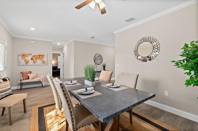 dining space with light hardwood / wood-style floors, ceiling fan, and crown molding