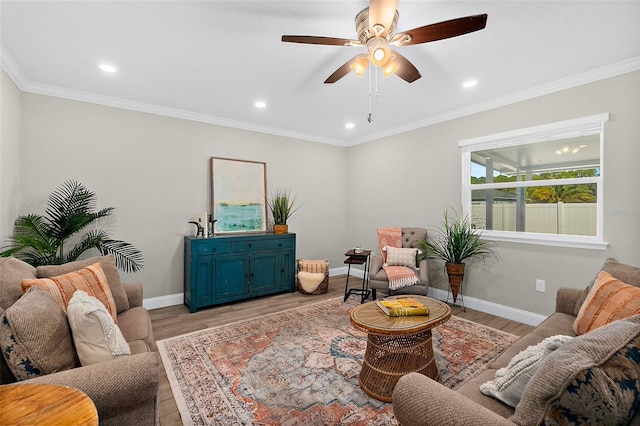 living room with light hardwood / wood-style flooring, ceiling fan, and crown molding