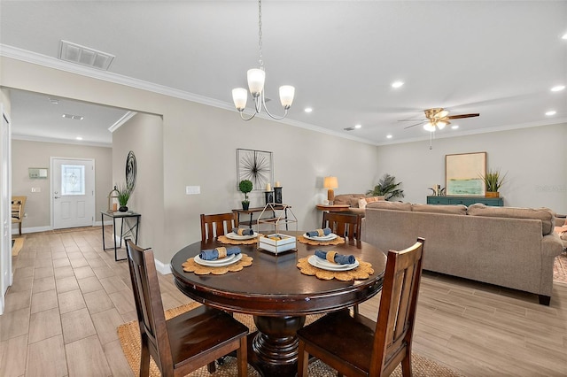 dining room with ceiling fan with notable chandelier and crown molding