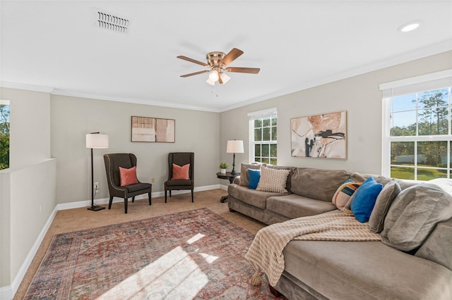 living room featuring carpet flooring, ceiling fan, and crown molding