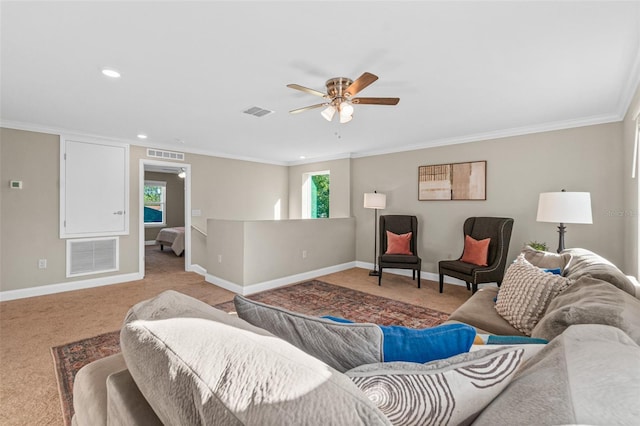 carpeted living room with ceiling fan and ornamental molding