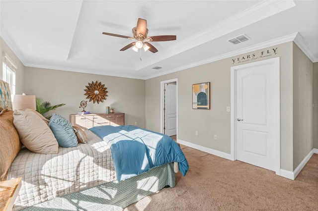 bedroom with a raised ceiling, ceiling fan, and ornamental molding