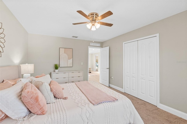 carpeted bedroom with ceiling fan and a closet