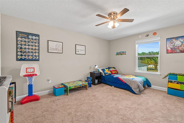 carpeted bedroom with ceiling fan and a textured ceiling