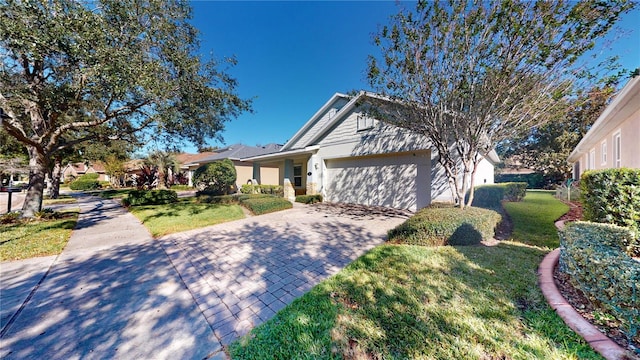 view of front of home featuring a front yard and a garage