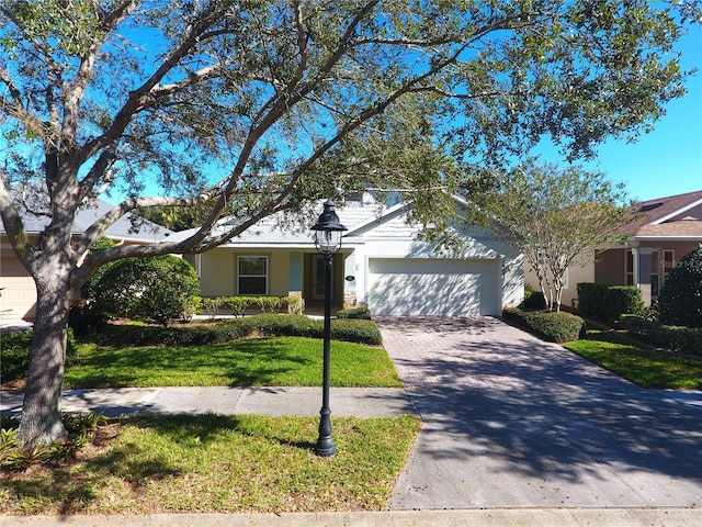 view of front of house with a garage and a front lawn