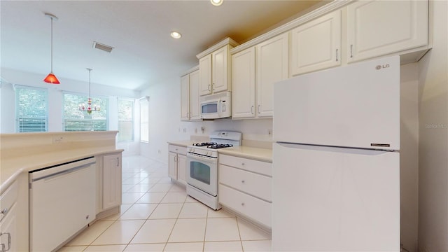 kitchen featuring pendant lighting, white appliances, and light tile patterned floors