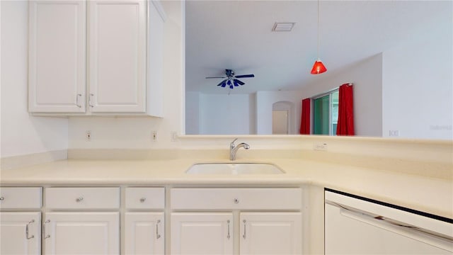 kitchen with white dishwasher, white cabinets, sink, hanging light fixtures, and ceiling fan