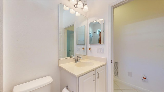 bathroom featuring toilet, vanity, and tile patterned floors