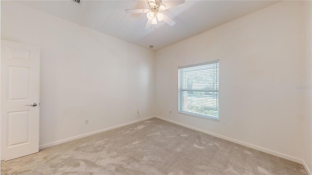 carpeted empty room with ceiling fan and lofted ceiling