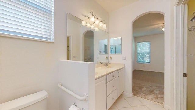 bathroom featuring toilet, vanity, tile patterned floors, and ceiling fan