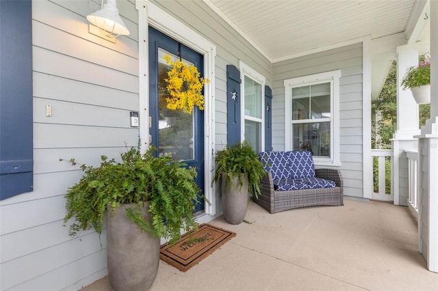 view of exterior entry with a porch