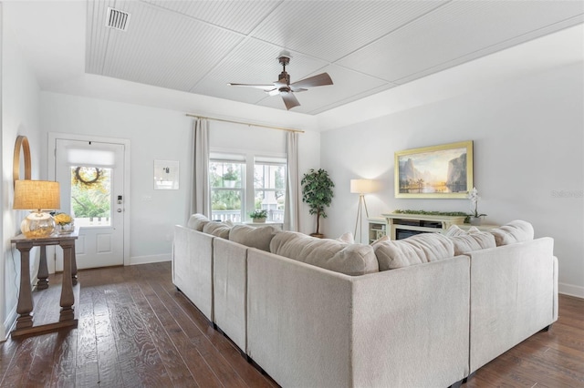 living room with ceiling fan, dark wood-type flooring, and a healthy amount of sunlight