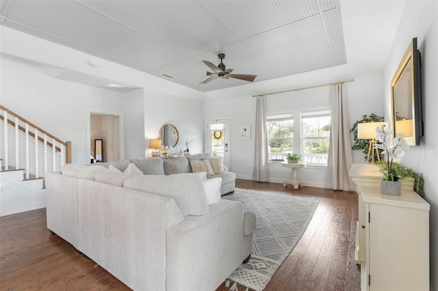 living room with dark wood-type flooring and ceiling fan