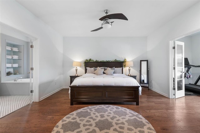 bedroom featuring ceiling fan, ensuite bath, and dark hardwood / wood-style floors