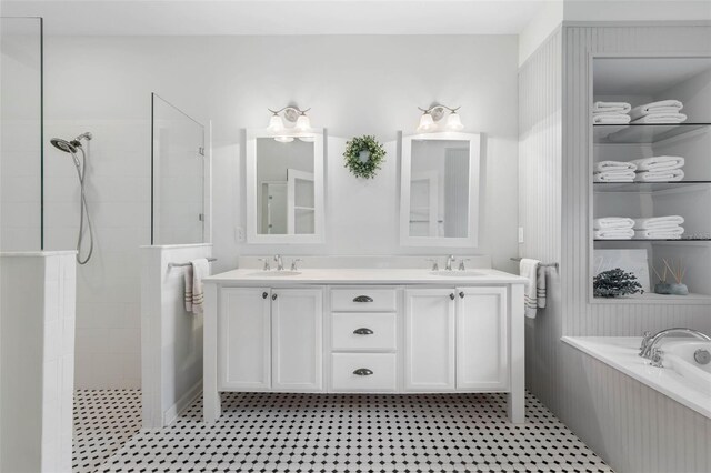 bathroom featuring vanity and shower with separate bathtub