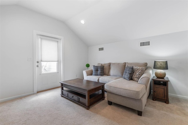 living room with lofted ceiling and light colored carpet