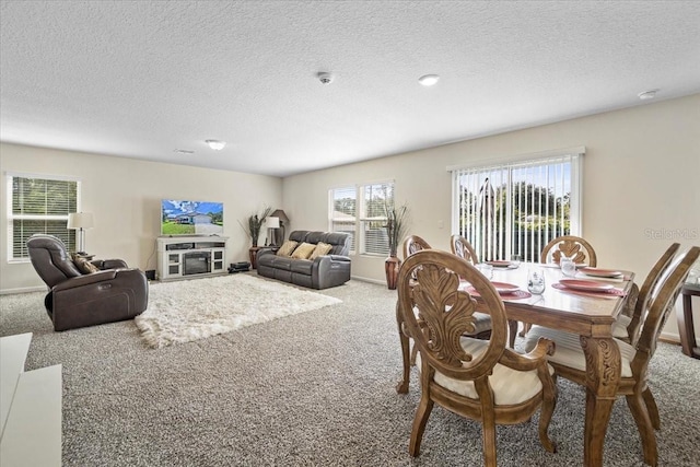 dining area with carpet floors and a textured ceiling