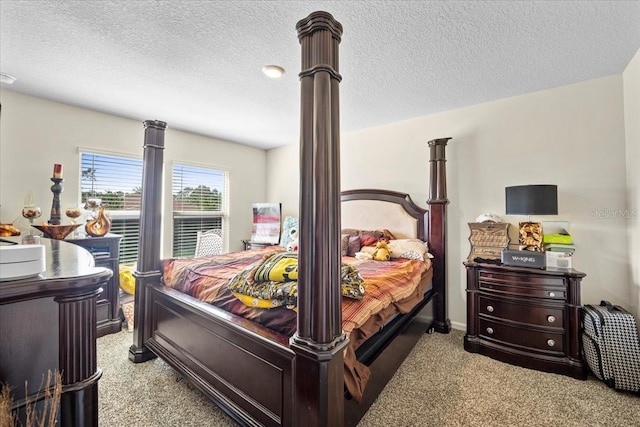 bedroom featuring light colored carpet and a textured ceiling