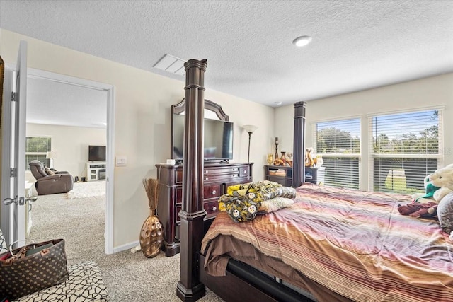 bedroom with light carpet and a textured ceiling