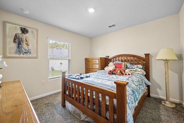 carpeted bedroom with a textured ceiling