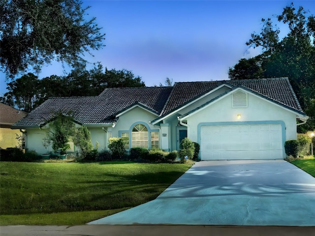 single story home featuring a front yard and a garage