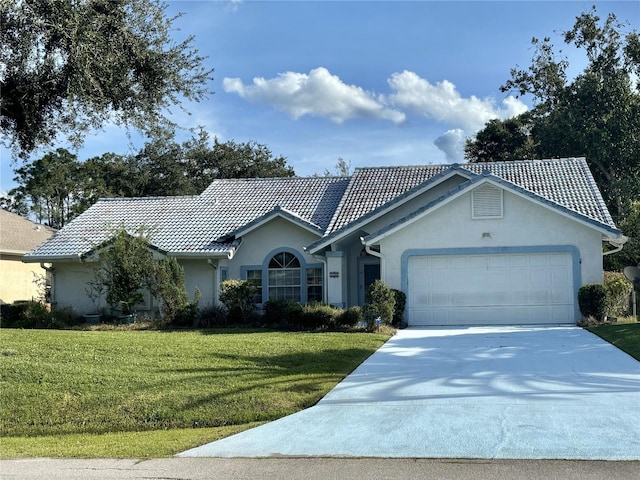 ranch-style house with a front yard and a garage