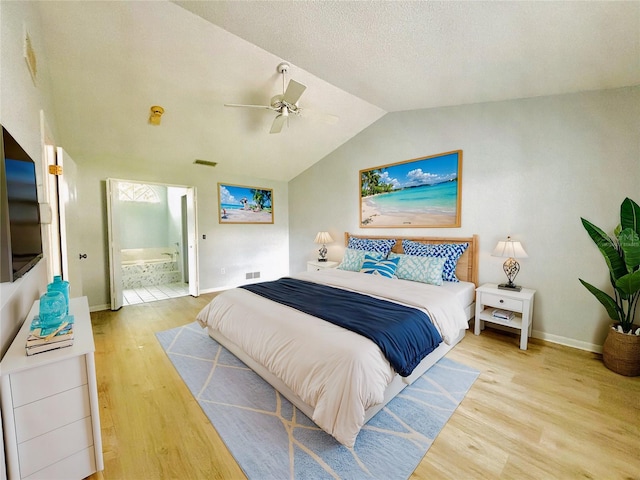 bedroom with lofted ceiling, light hardwood / wood-style flooring, ensuite bathroom, and ceiling fan