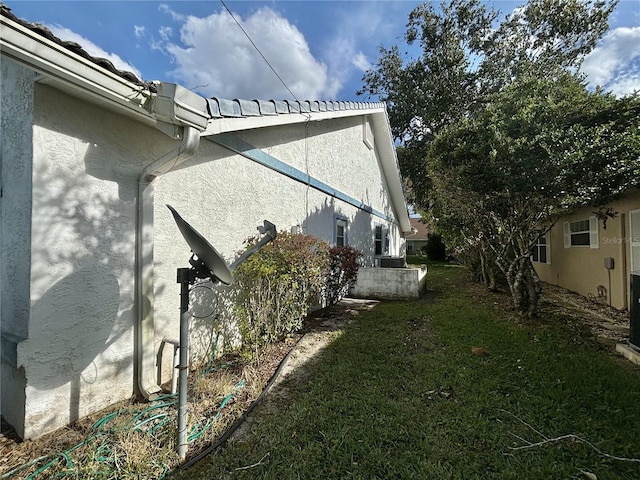 view of side of property with a yard